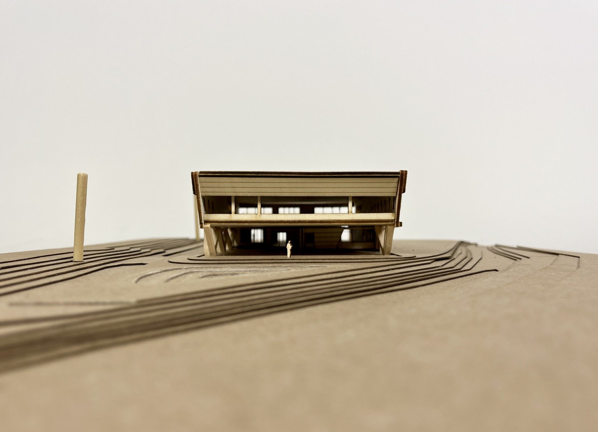 Frontal view of the LSU Campus Health Center study model, showing the open ground level entry beneath the cantilevered upper volume