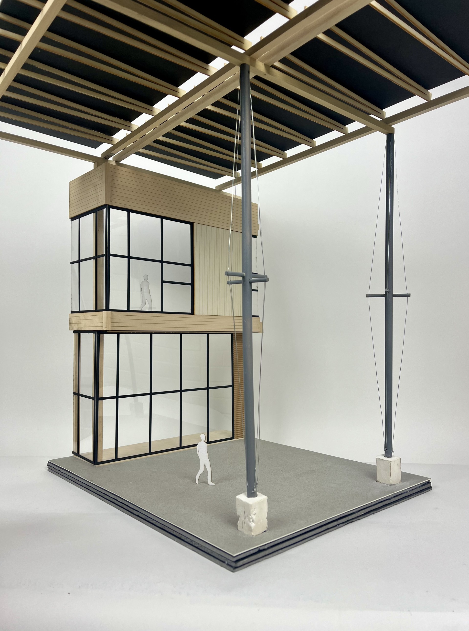 Physical case study model of the Kendeda Building at Georgia Tech, showing the two-story glazed volume beneath its overhead roof structure