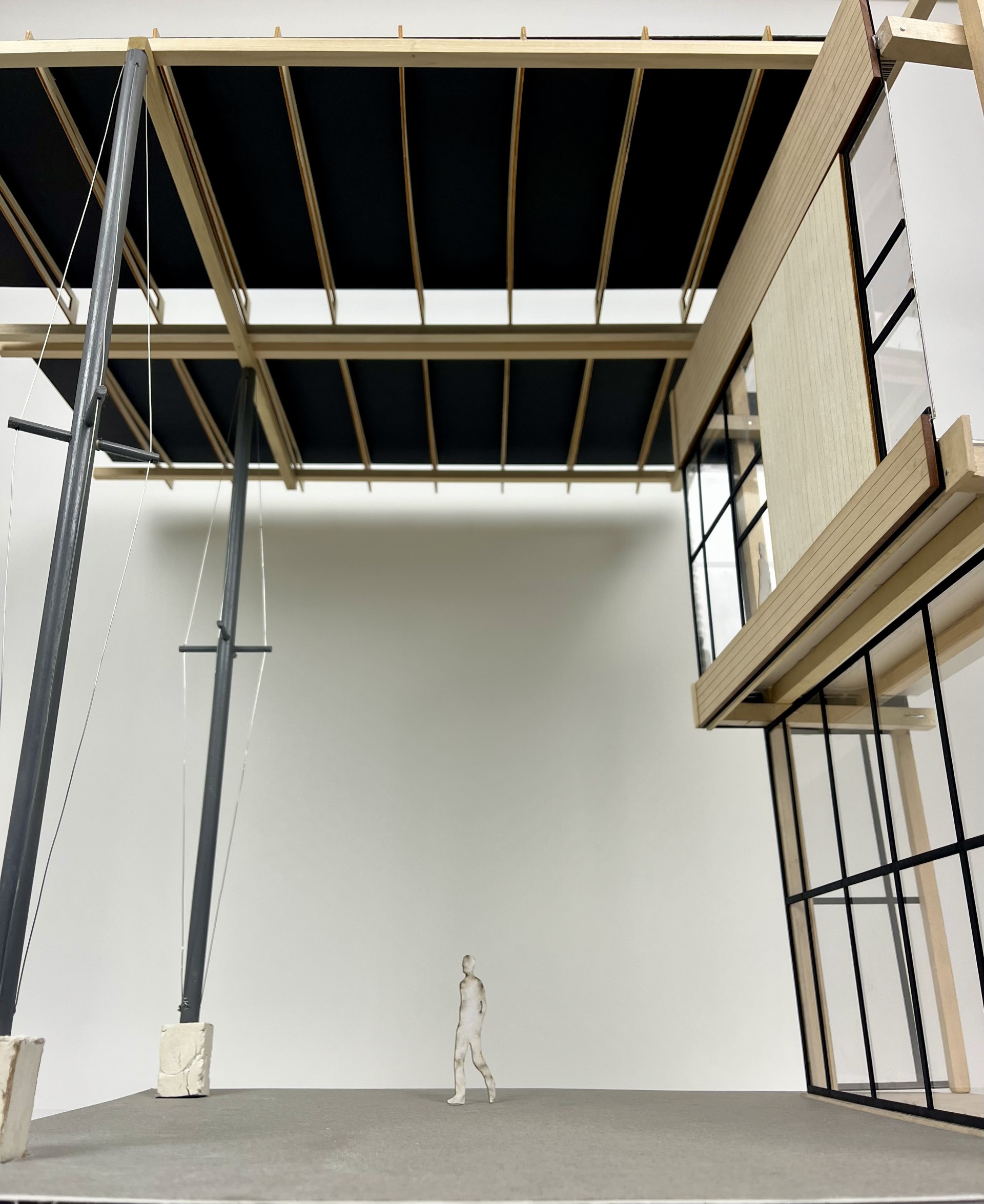 Interior courtyard view of the Kendeda Building case study model beneath the roof structure, with a scale figure